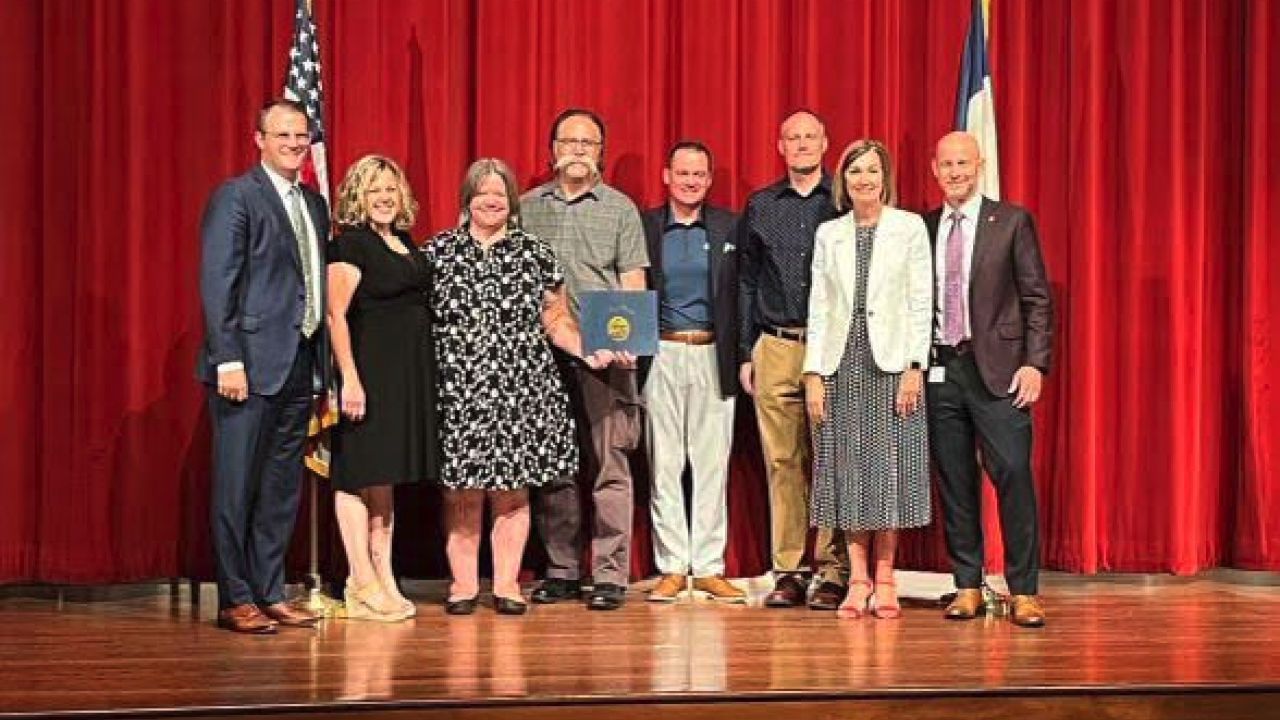 People standing on a stage together