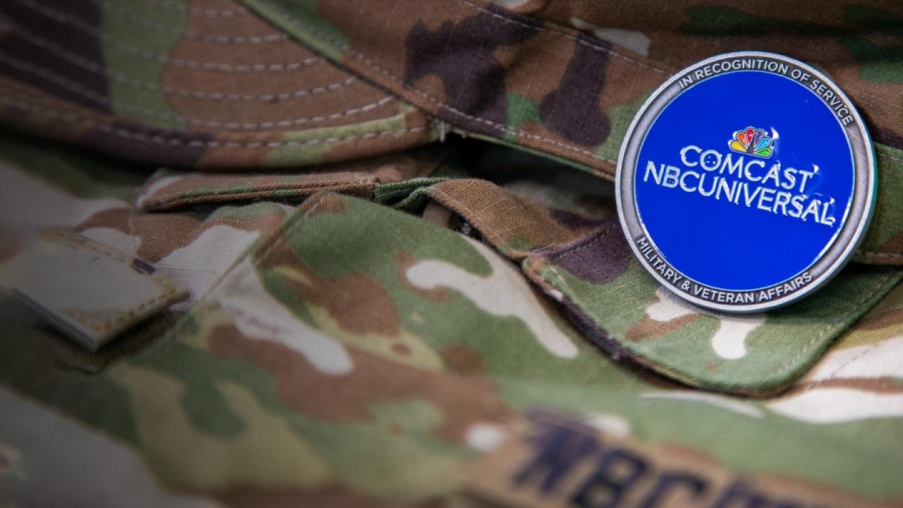Military uniform with a pin that reads "in recognition of service, military & veteran affairs"