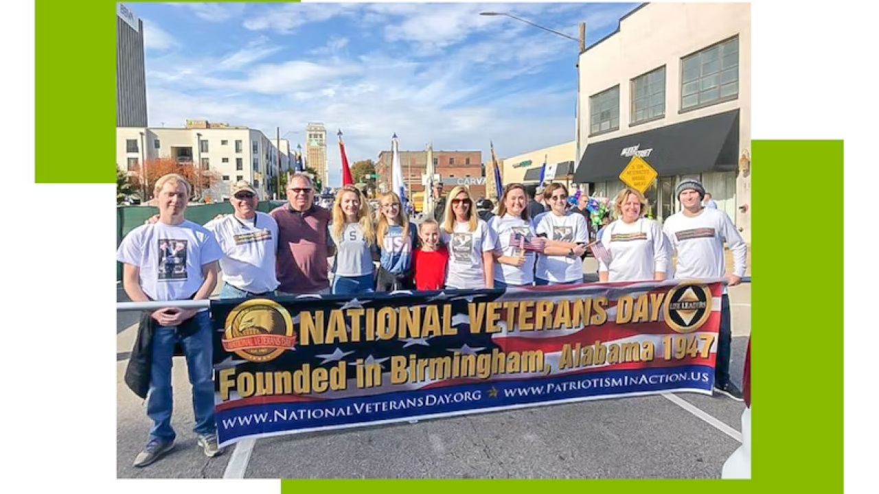 Group of people holding a Veterans day banner