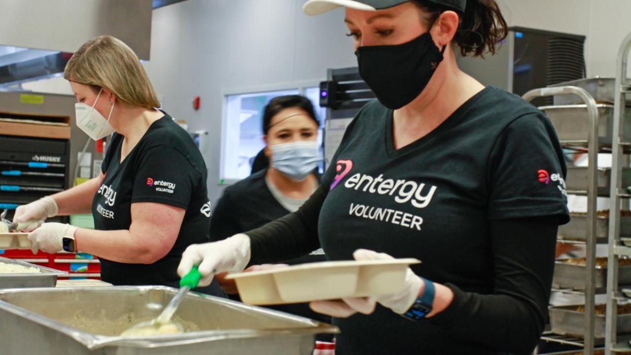 volunteers in masks serving food