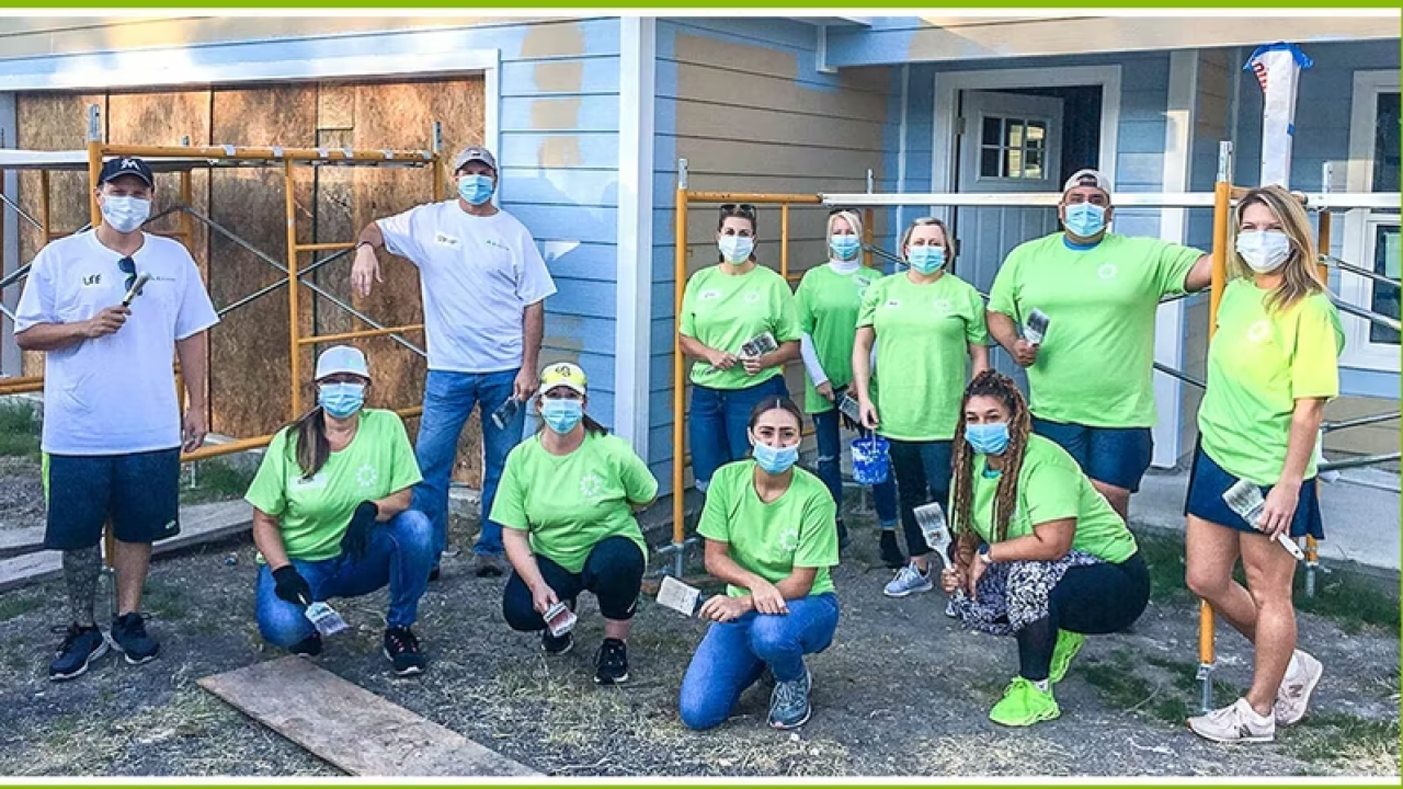Volunteers outside a home