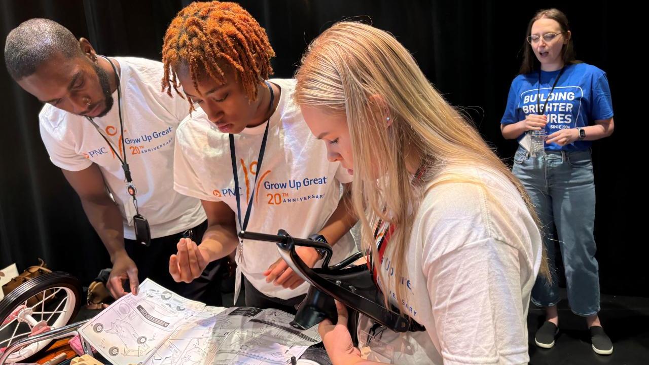 Interns and volunteers working together to assemble bikes and wagons.