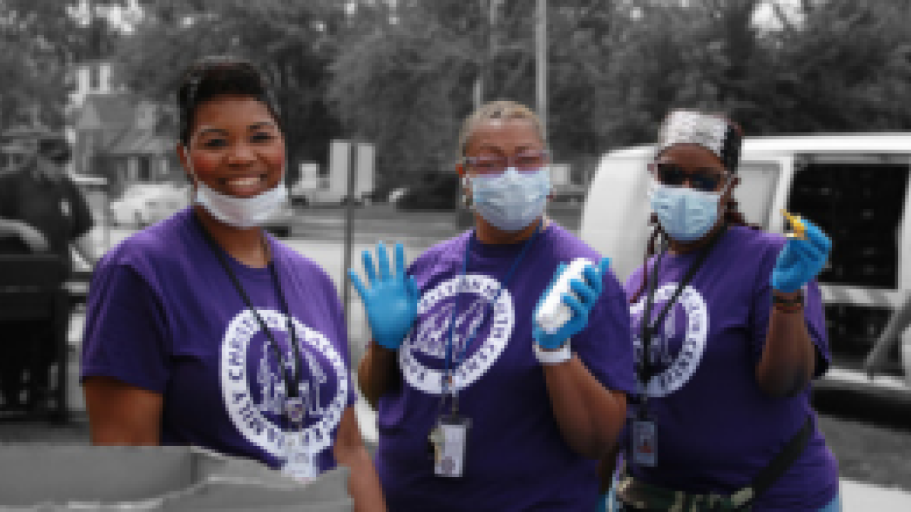 Three volunteers wearing rubber gloves