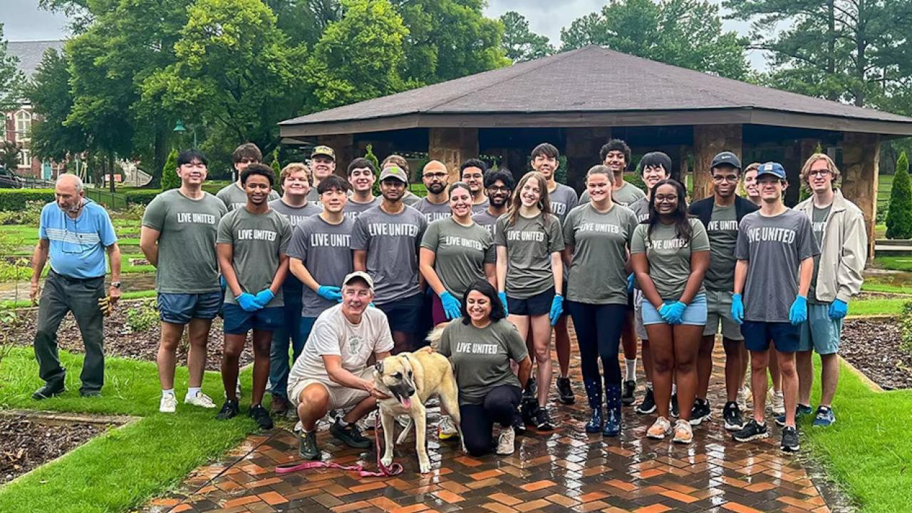The group of volunteers posed in a park setting.