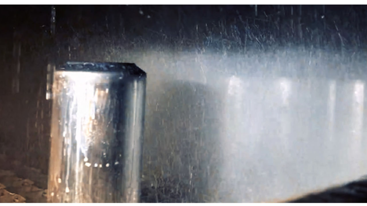 A piece of metal being sprayed with water