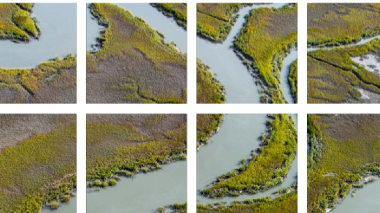 large pixels aligned to reveal an aerial photo of a winding water way.