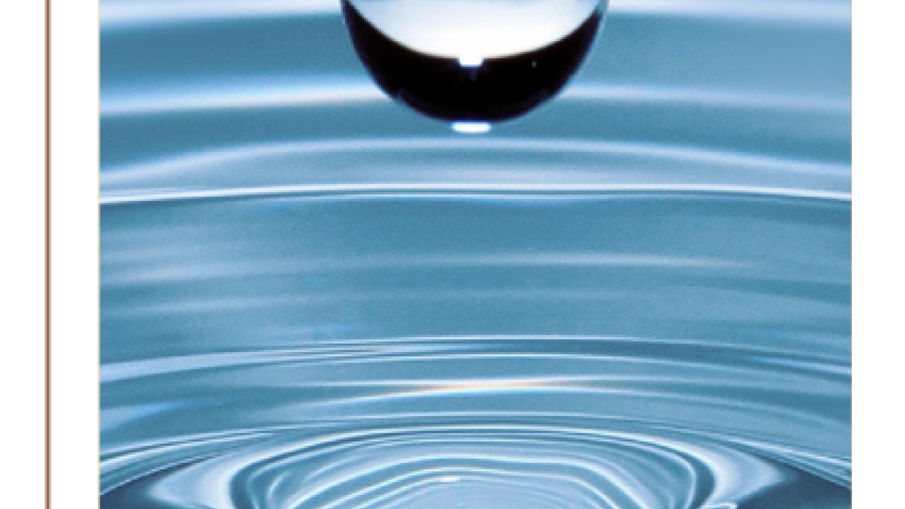 Close up of a water drop above a pool of water.