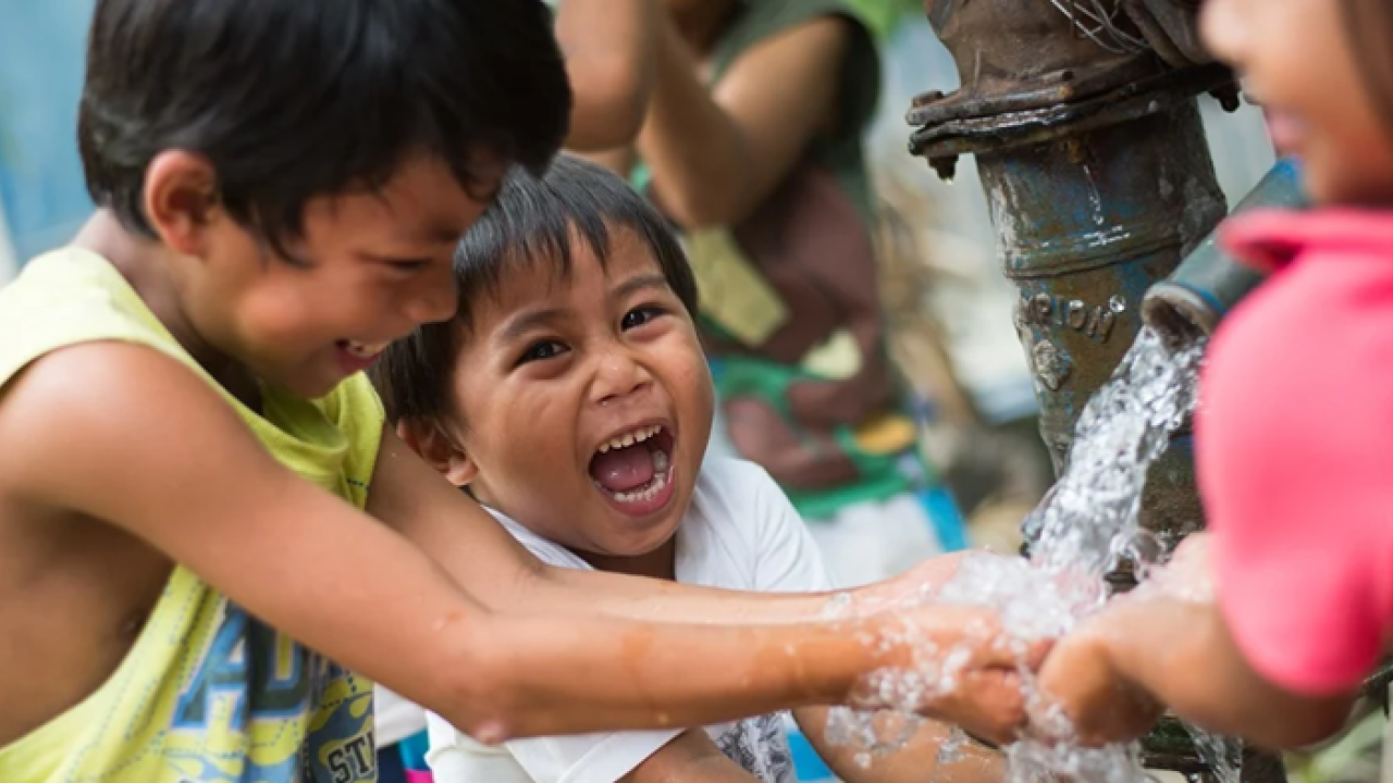 Kids playing in running water