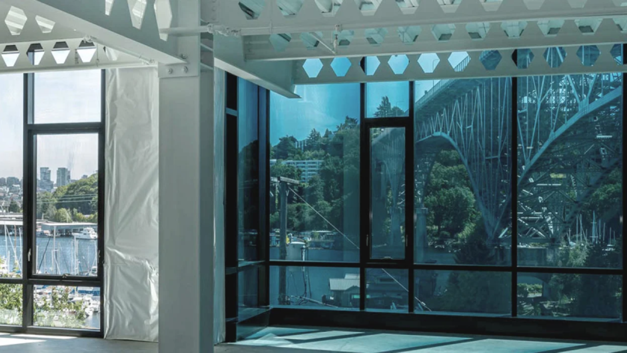 building with floor to ceiling windows looking out to bridge