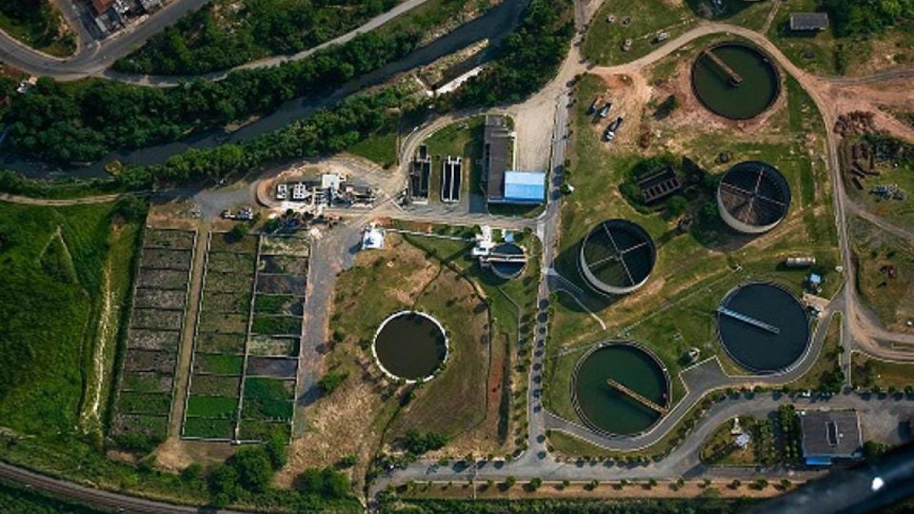 aerial view of a water treatment facility, many large pools of water and buildings.