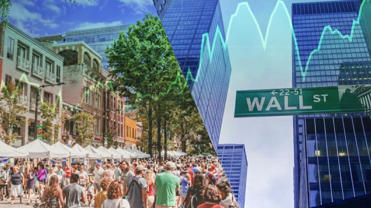 people walking down Wall St.