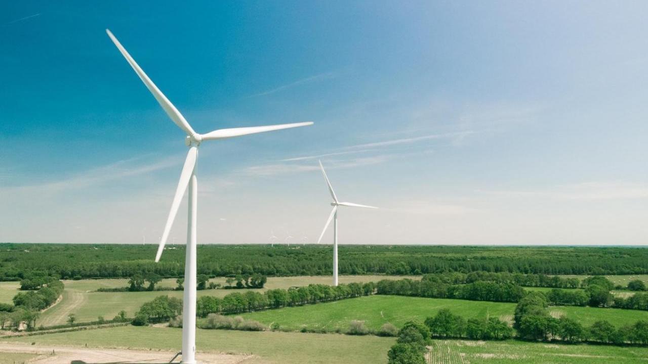 Wind turbines in an open area, clear sunny weather.