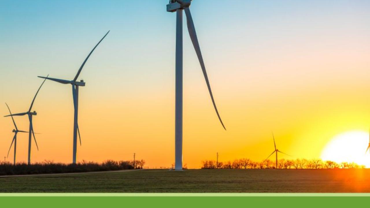 Photo of wind turbines with the text, "Net Zero Commitment First Anniversary, Whirlpool"