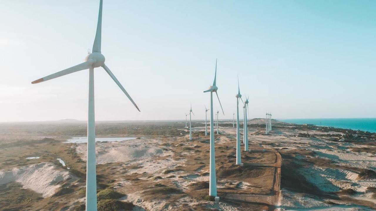 A row of wind turbines on desolate expanse of land