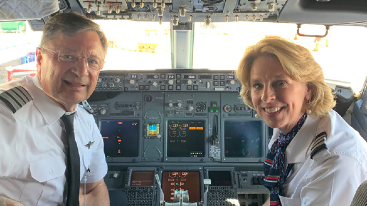 two pilots in the cockpit of a plane