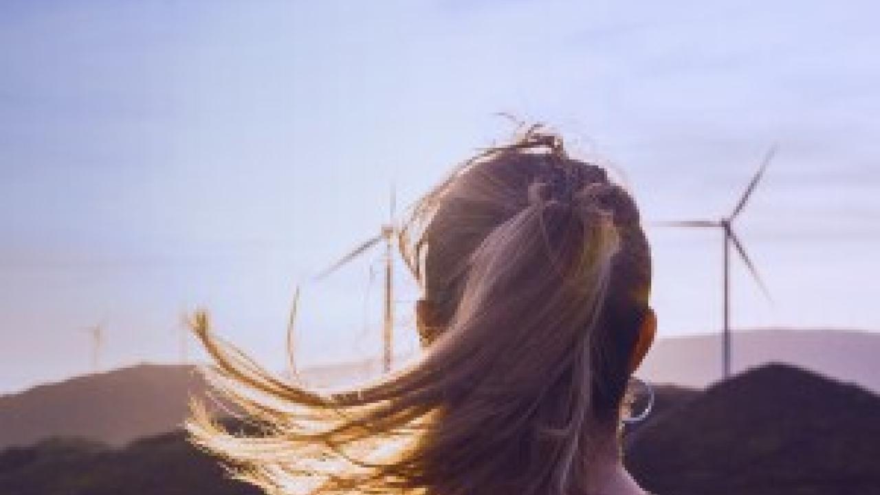 Woman looking at windmills