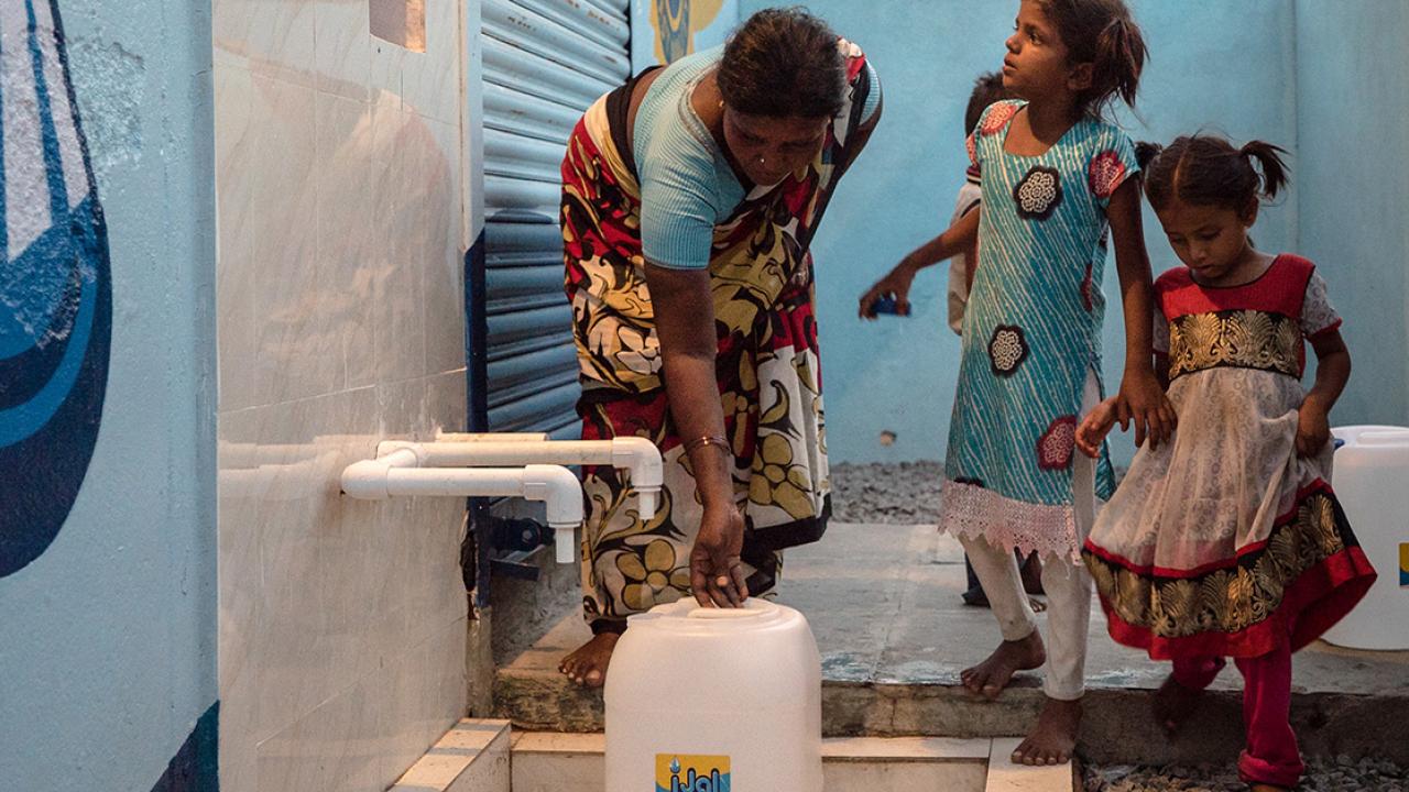woman and children collect water