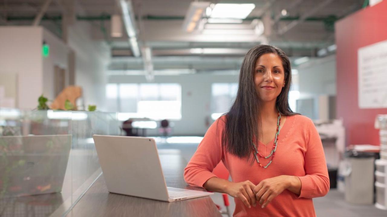 woman standing next to a computer