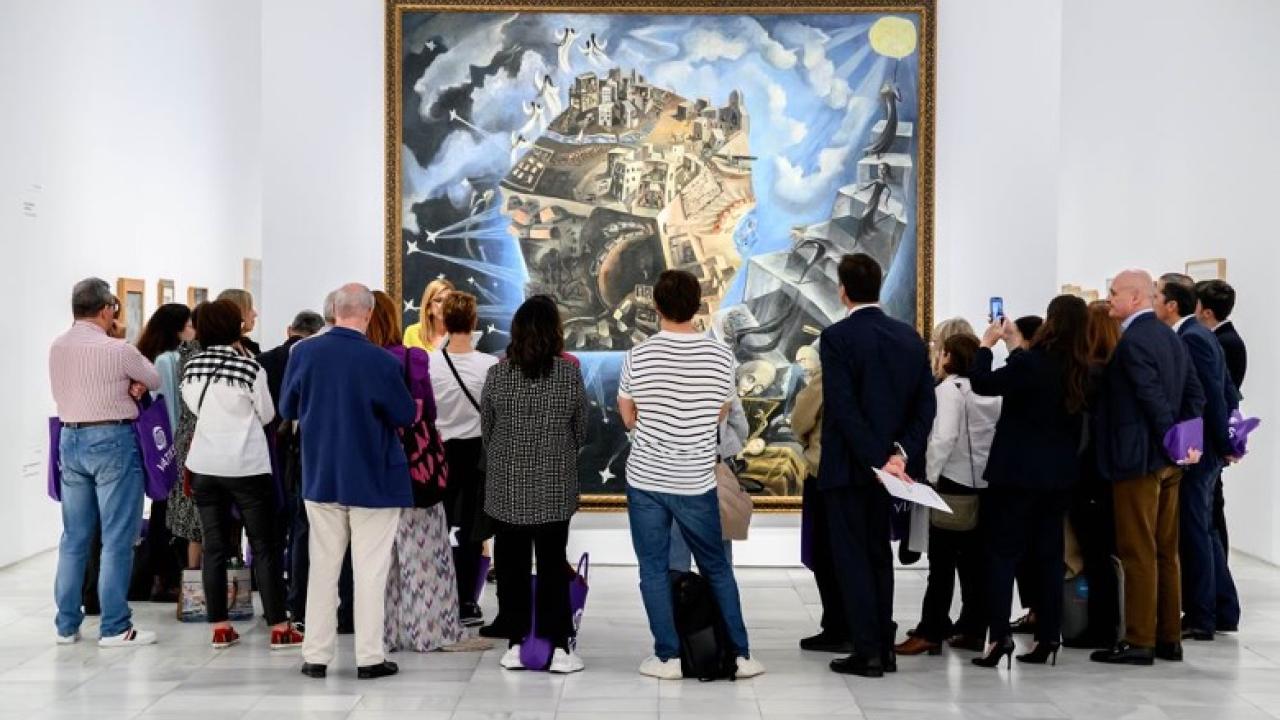 A small crowd admiring a large painting