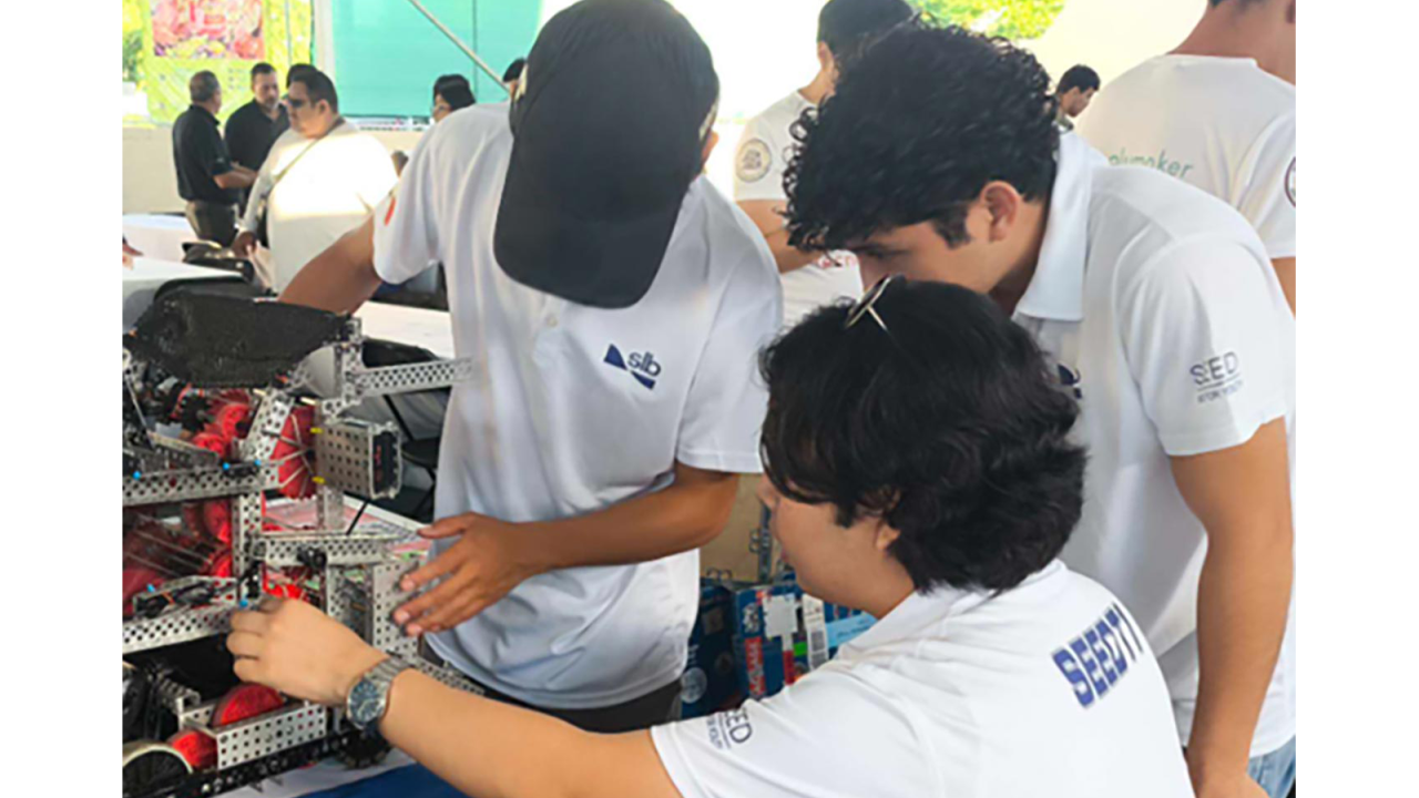 three students working on a project