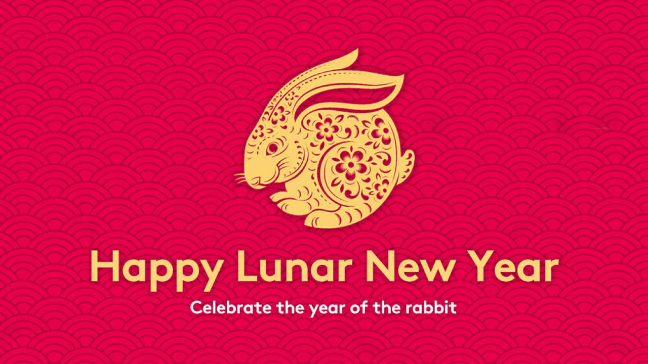 On a red background, a gold, intricately designed rabbit, and "Happy Lunar New Year Celebrate the year of the rabbit."
