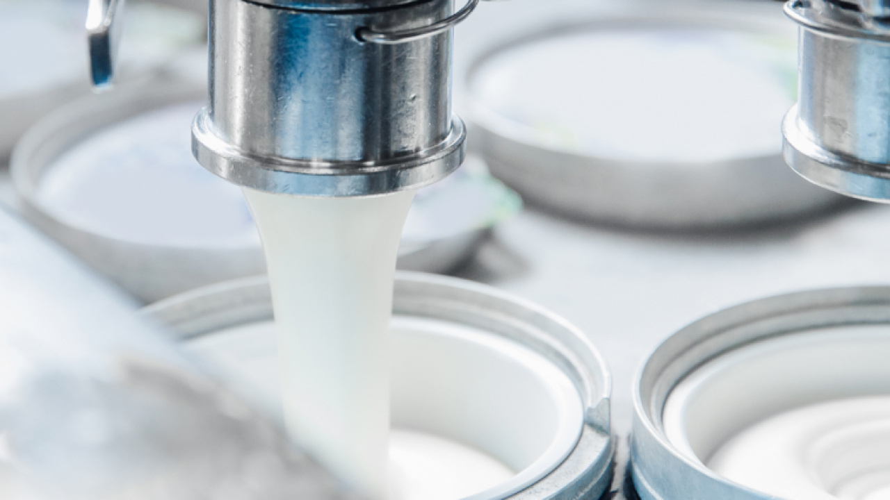 close up of a dairy product being filled into containers