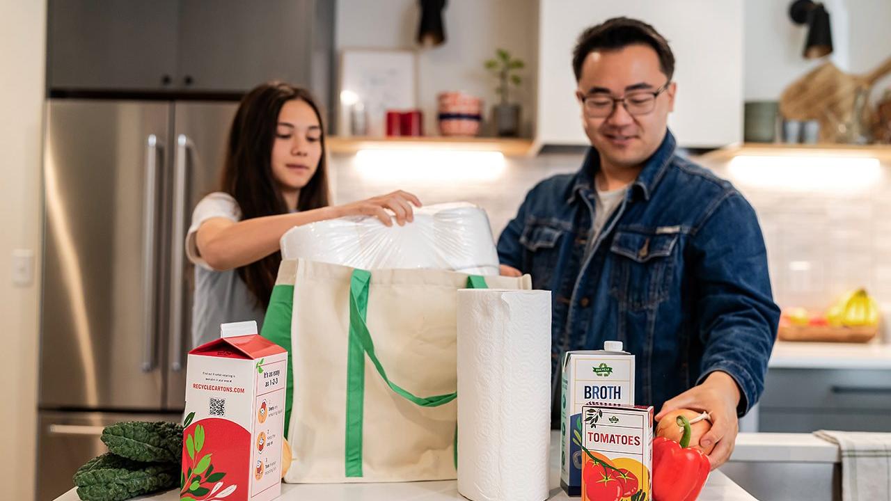 Two people unpacking groceries
