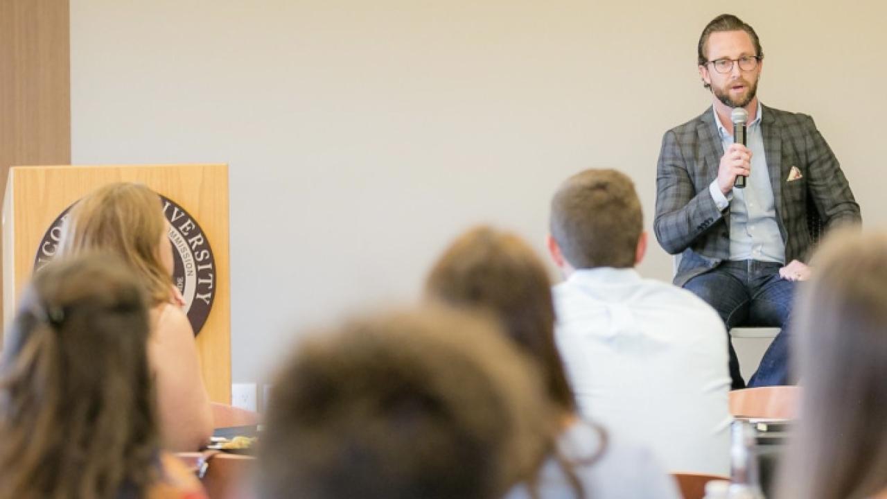 Person speaking in front of a class
