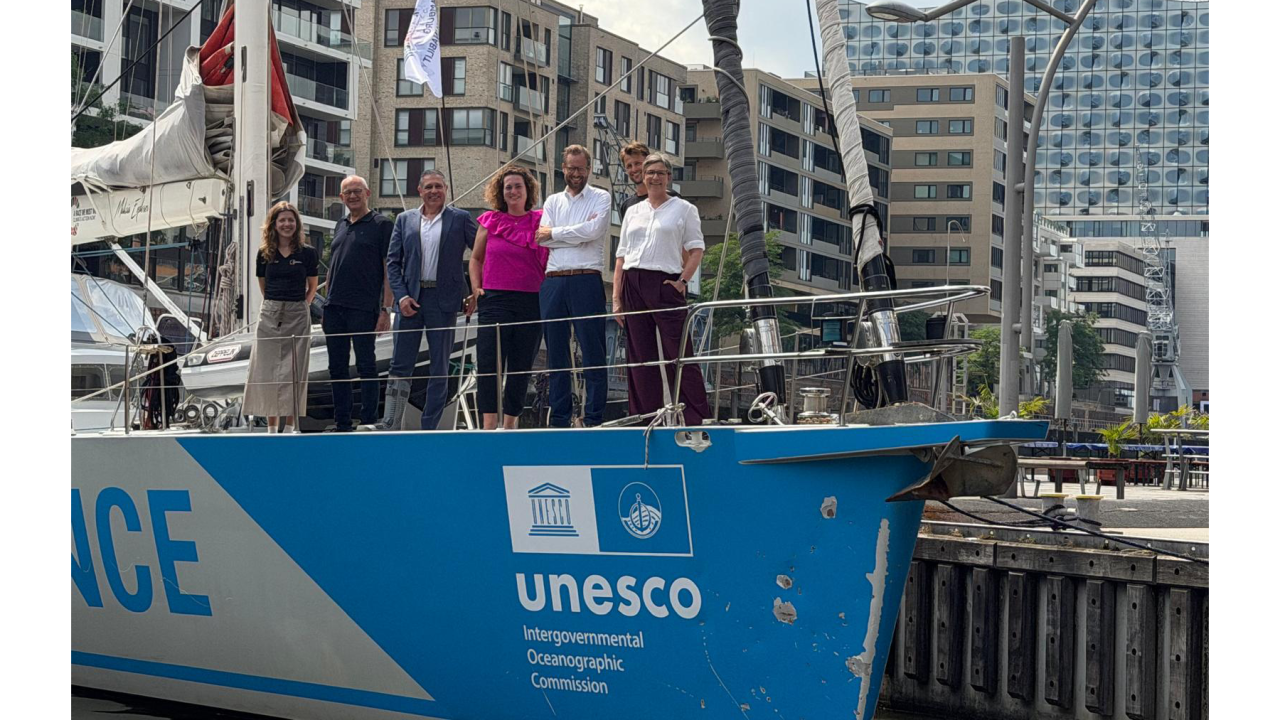 People standing on bow of ship