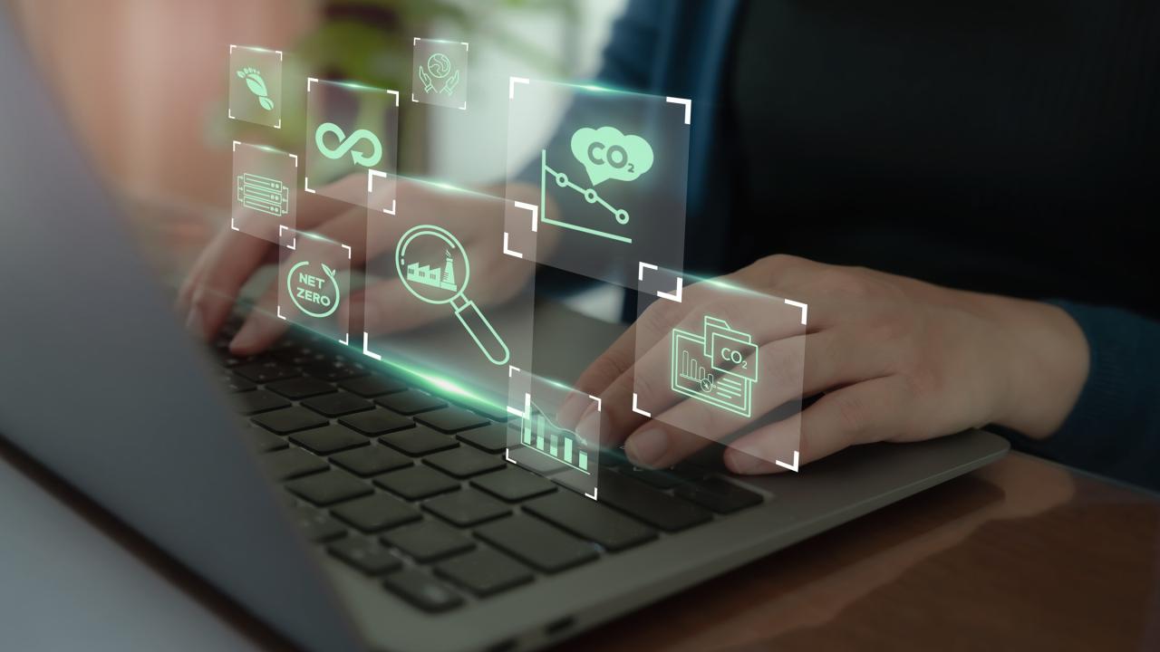Using a laptop with digital icons representing digital tools used environmental monitoring.