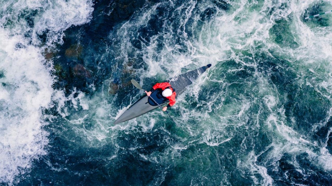 Kayak shown in rough waters.