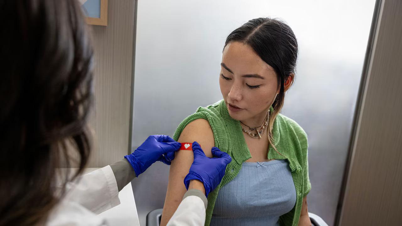Patient having a band aid applied.