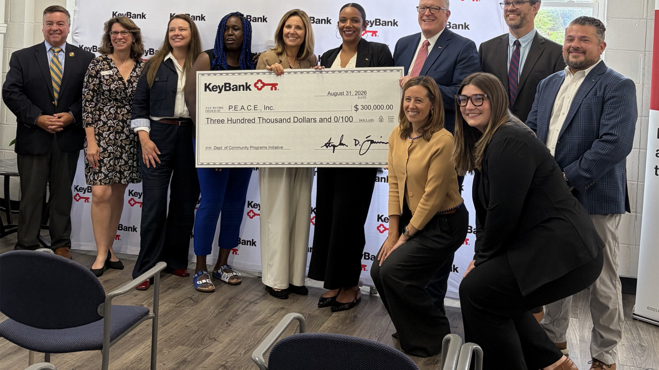 Group posing with an oversized check