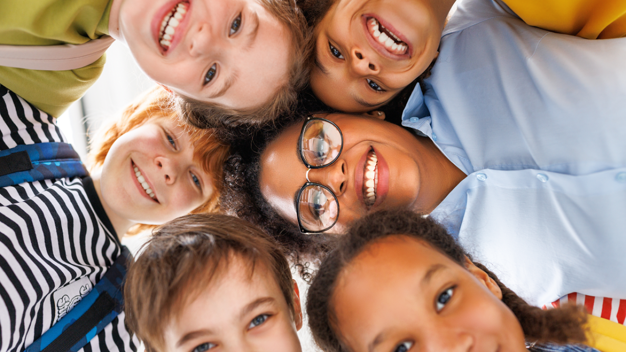 Children gathered together and smiling at the camera