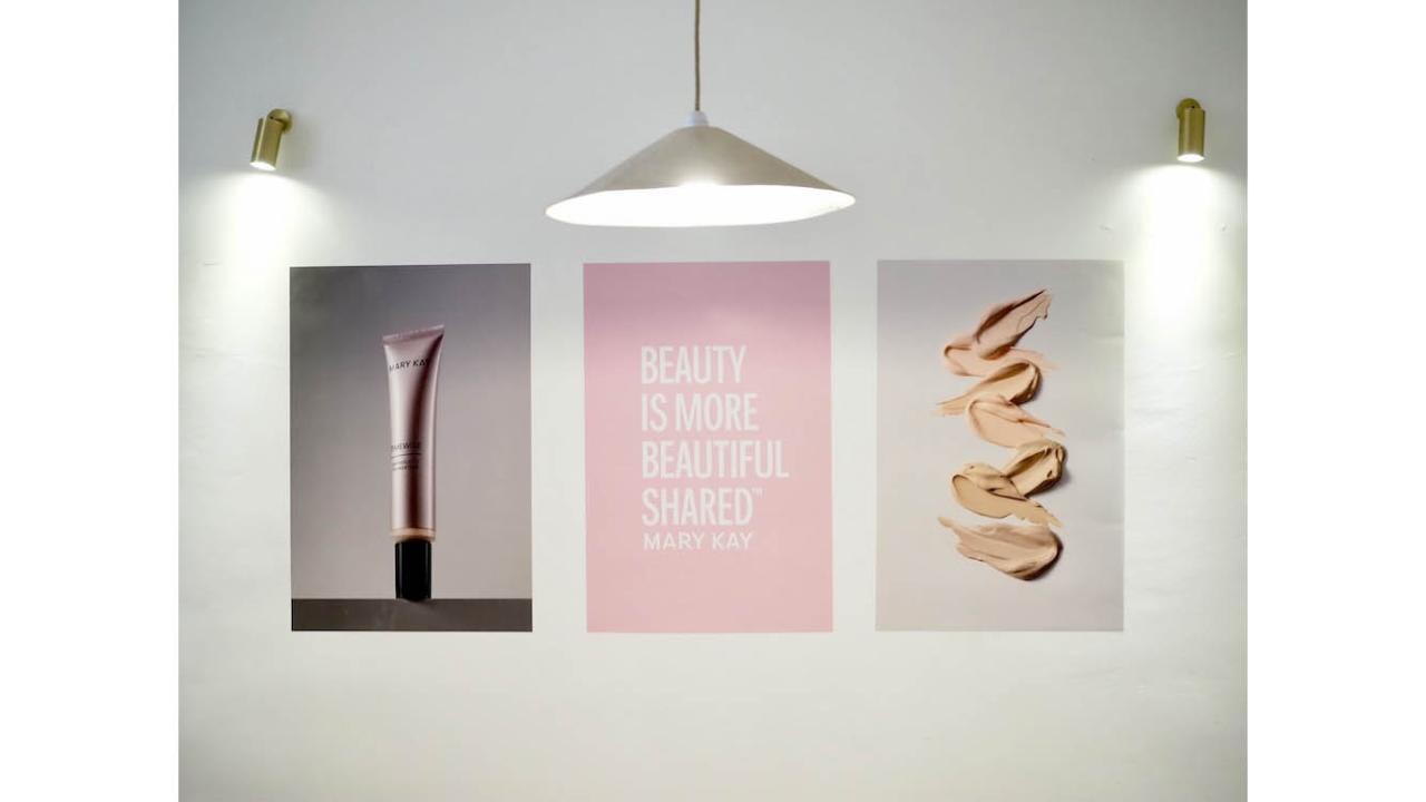 Artwork on wall with a poster reading "Beauty Is More Beautiful Shared"