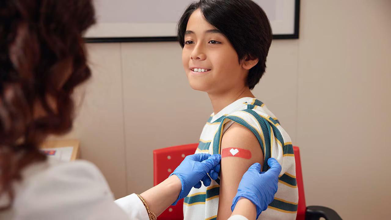 Patient shown with a medical professional.