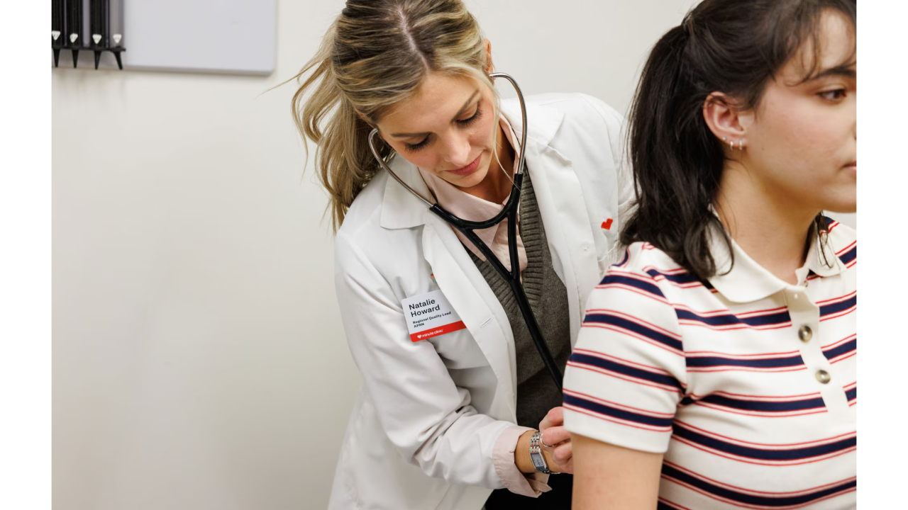 Doctor listening to patient's heartbeat