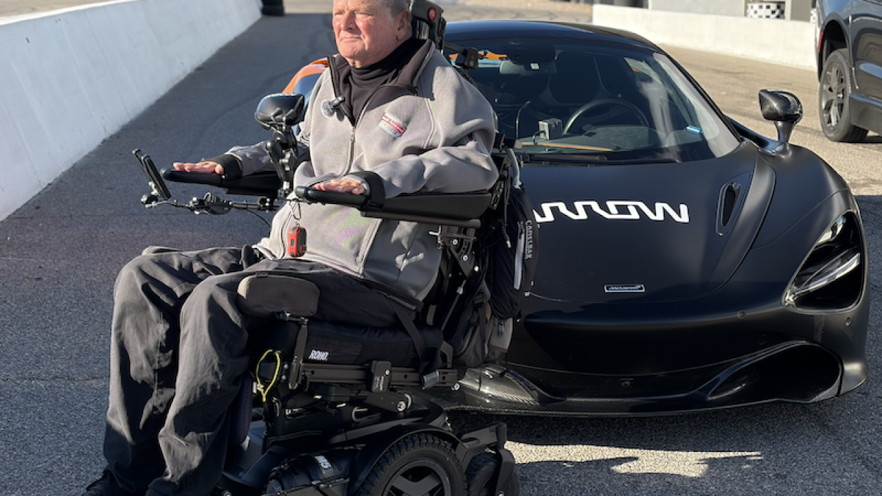 Sam seated outside the Arrow SAM car