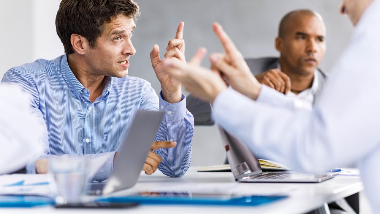 People arguing across an office table