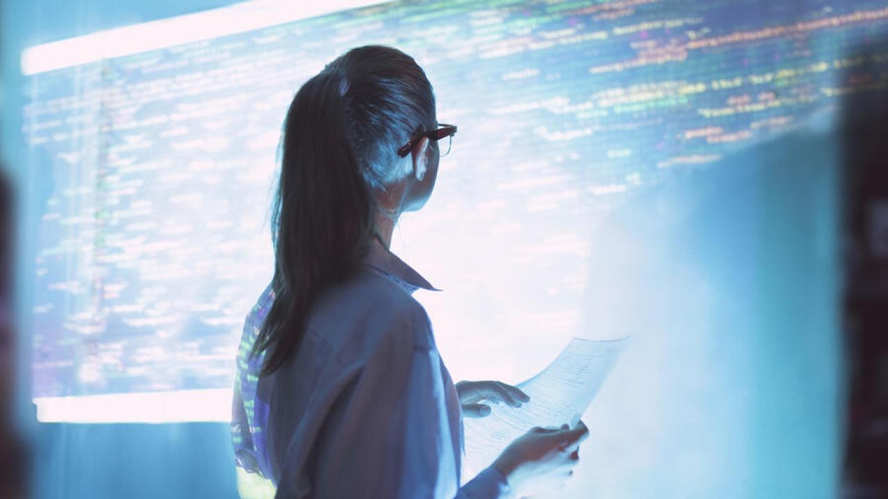 person looking at a screen of computer code