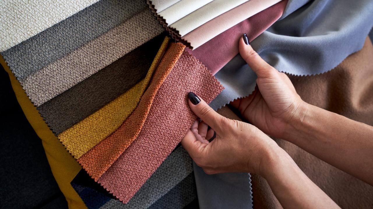 A woman's hand holding colorful fabric swatches