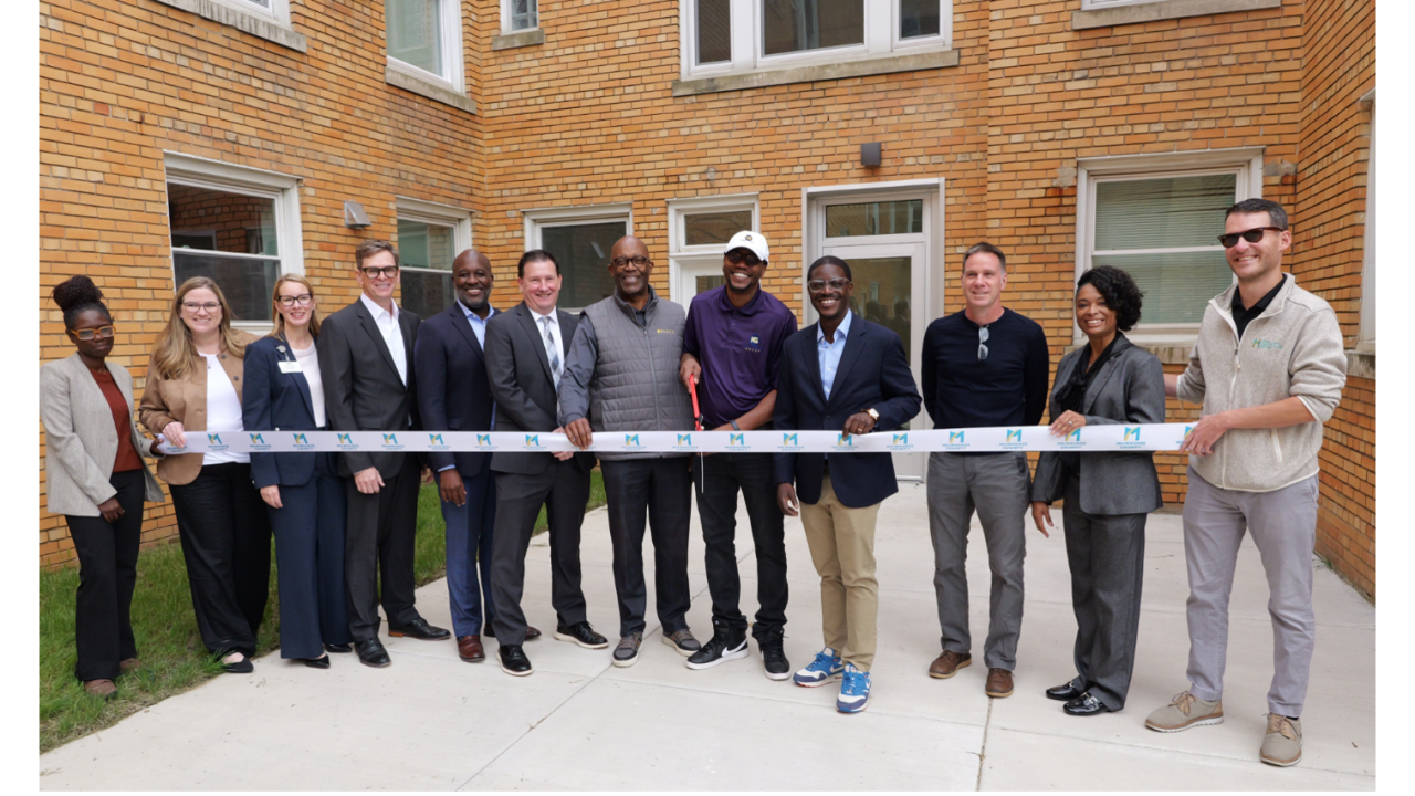 Ribbon cutting ceremony outside a building