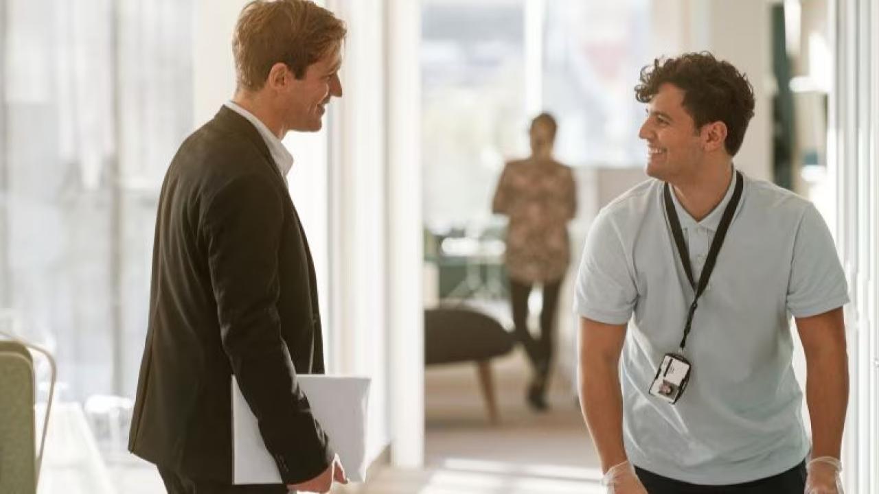 Two people having a discussion in an office.