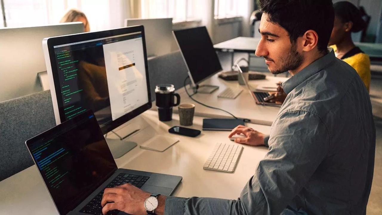 person coding at a computer