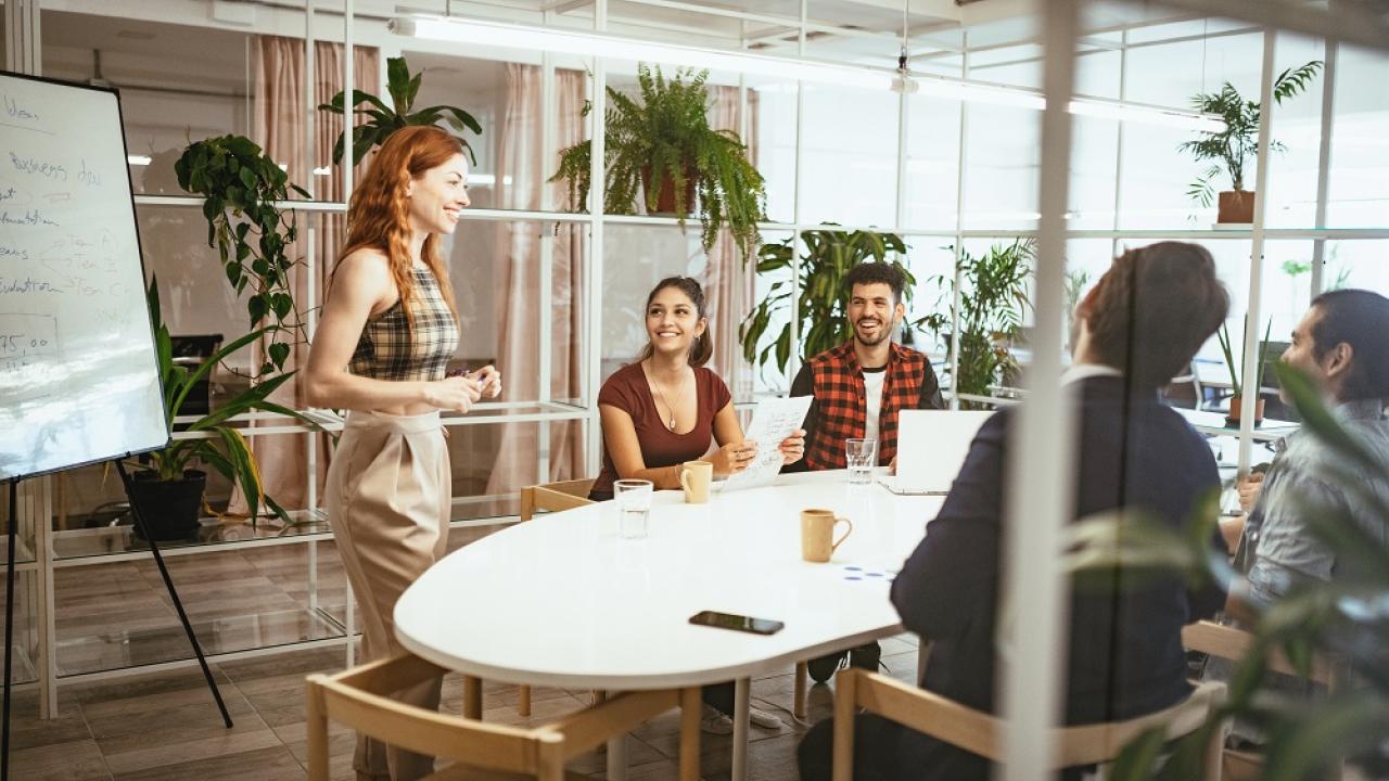 group of 4 sitting listening to a speaker